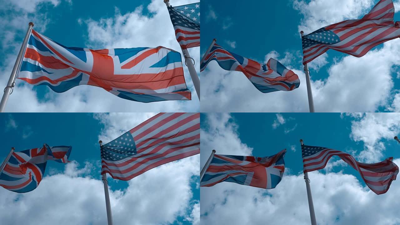 旗杆上的美国和英国国旗在蓝天下随风飘扬