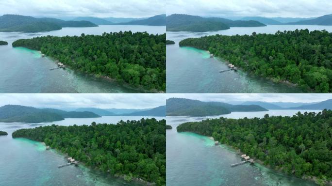 空中无人机拍摄了带有小屋的岛屿海岸线