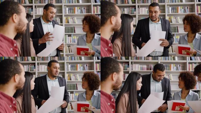 非裔美国教授站在图书馆校园里帮助青少年学生从事研究生工作