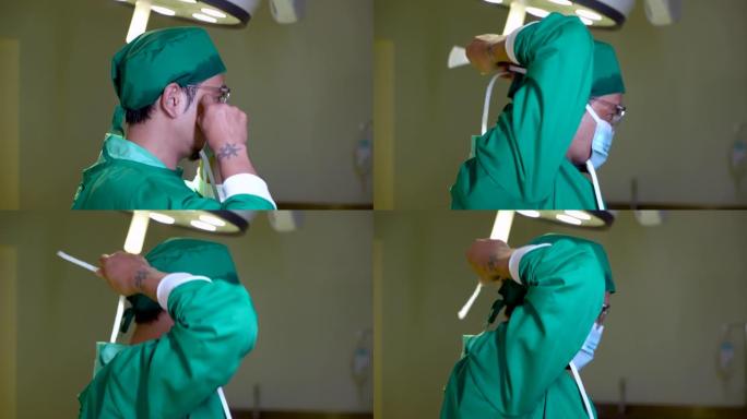 4K，医生穿着一件绿色的西装，适合在手术室里穿手术，戴着一顶帽子留着我的头发，他正在用手在嘴和鼻子上