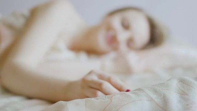 Young girl take ring from blanket after sleeping