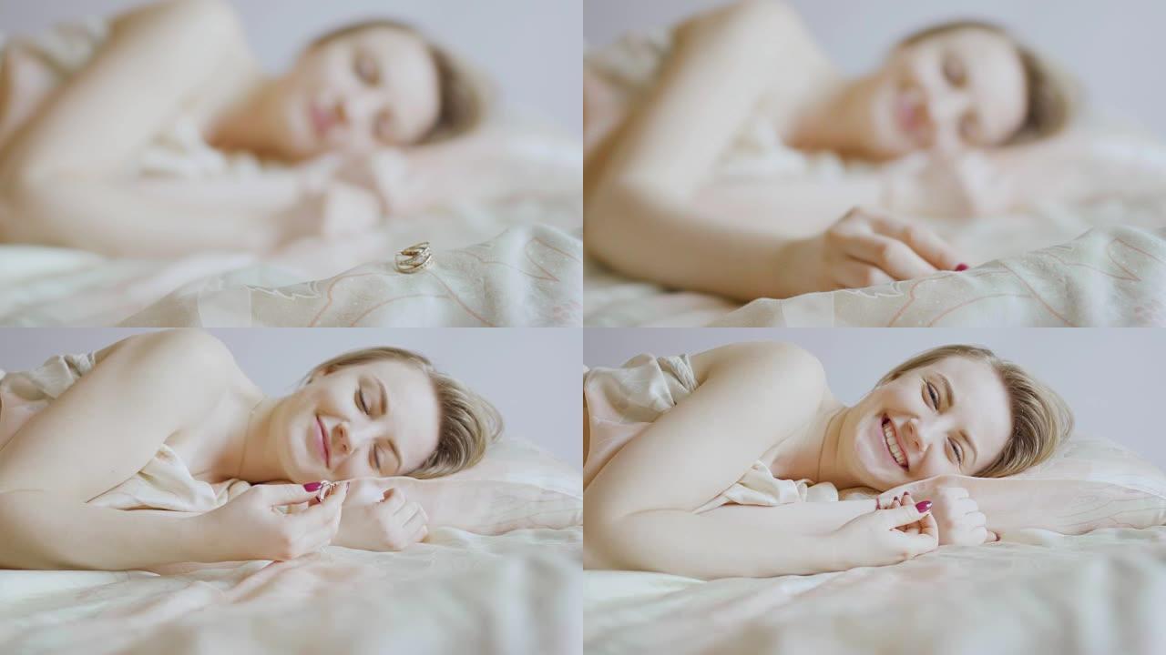 Young girl take ring from blanket after sleeping