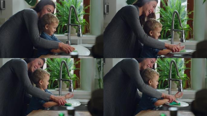 可爱的小男孩试图帮助他的母亲在厨房做家务和任务，用海绵洗盘子的手持镜头。女人教她蹒跚学步的儿子如何洗