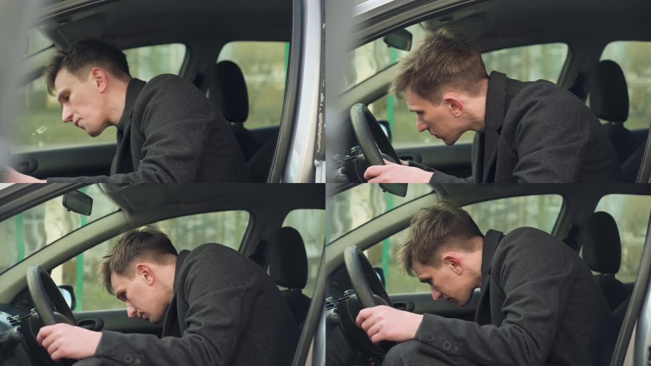 年轻的汽车司机正在检查他的第一辆汽车。特写