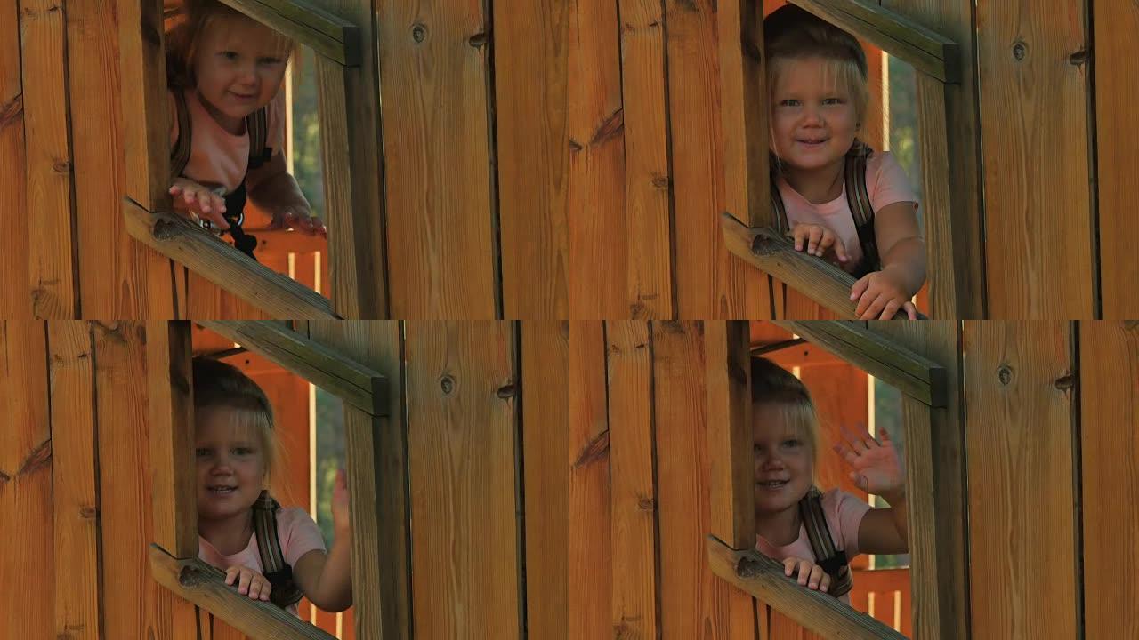小女孩从树上木屋的窗户向外看