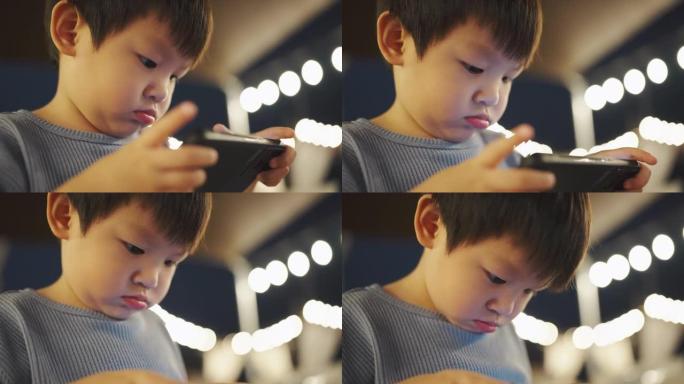 小男孩玩手机游戏小男孩电子幼儿