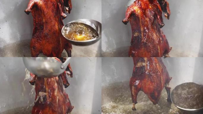 厨师用煮沸的油将整只鸭炒锅，厨师用钢包将热油倒在整只鸭上