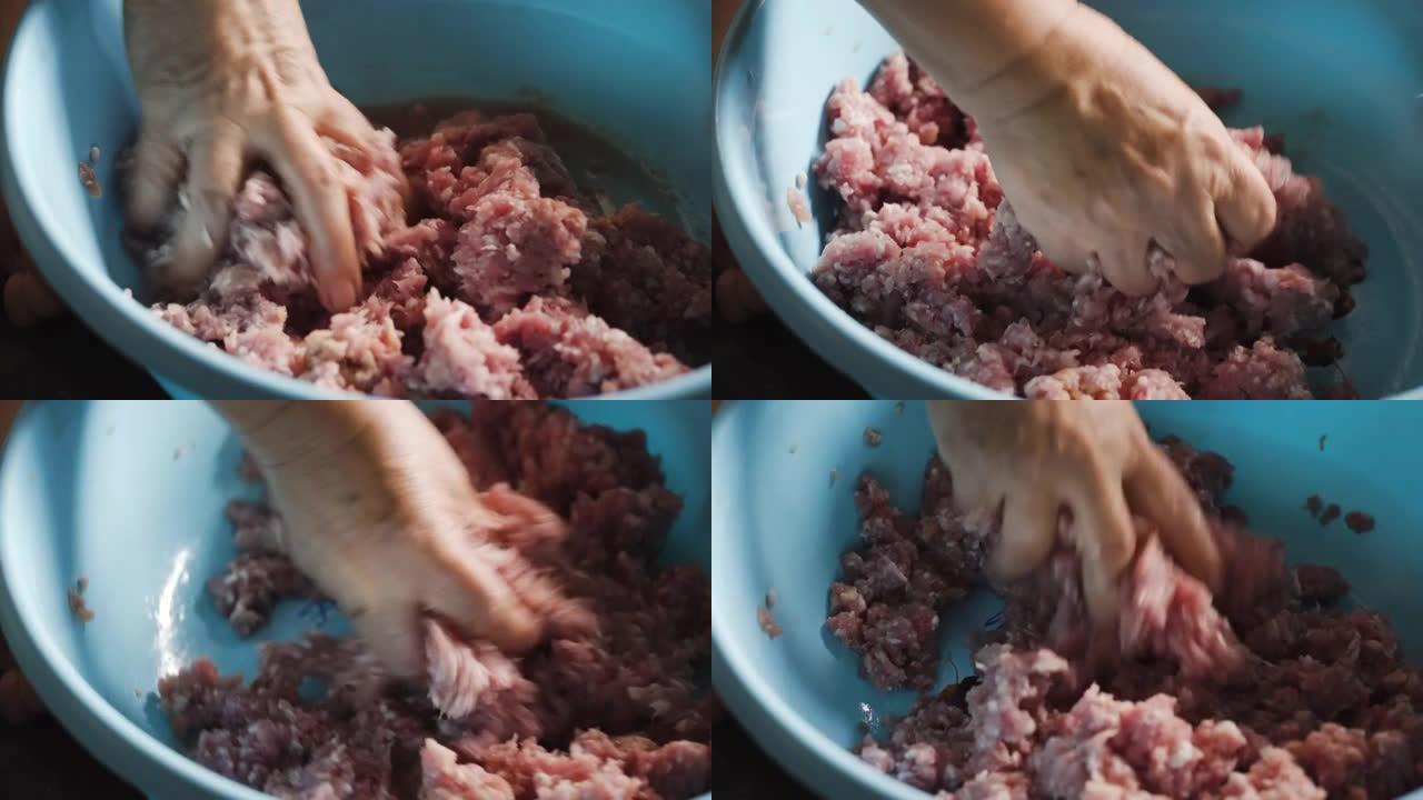 有人用手在碗里混合其他配料和猪肉末。为亚洲食物菜单准备肉类。