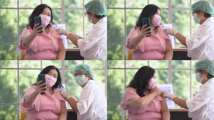 在诊所或医院接种covid疫苗时，通过电话自拍的超重亚洲女性肖像，手持护士注射疫苗以获得病毒免疫力。