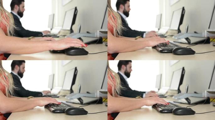 男人和女人在办公室的计算机上工作 (在键盘上打字) (工人)-特写手