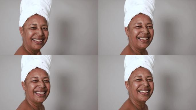 非洲高级女性在相机上微笑-美容日和护肤疗法概念