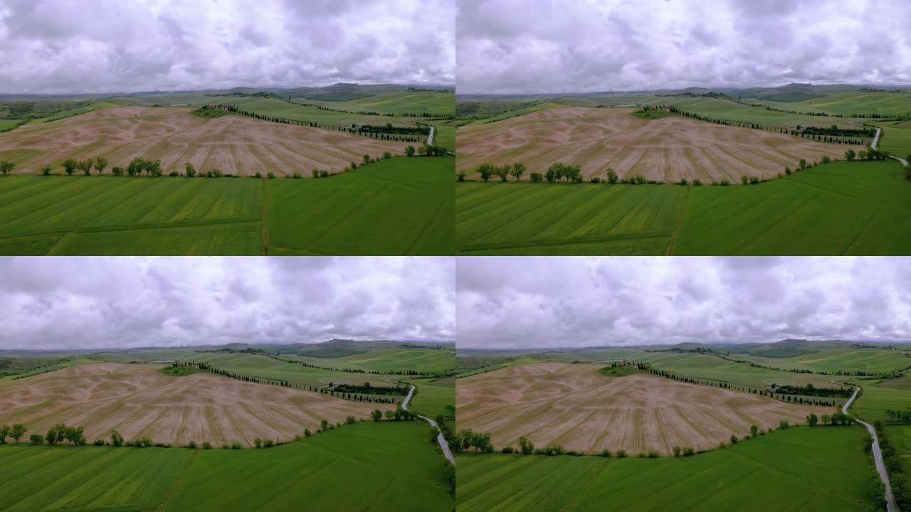 镜头-意大利托斯卡纳景观的鸟瞰图，起伏的丘陵和多云的天空