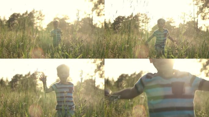 慢动作小男孩在夏日的草地上奔跑，带着美丽的日落光线穿过高高的草地。童梦，快乐的童年，自由的观念。