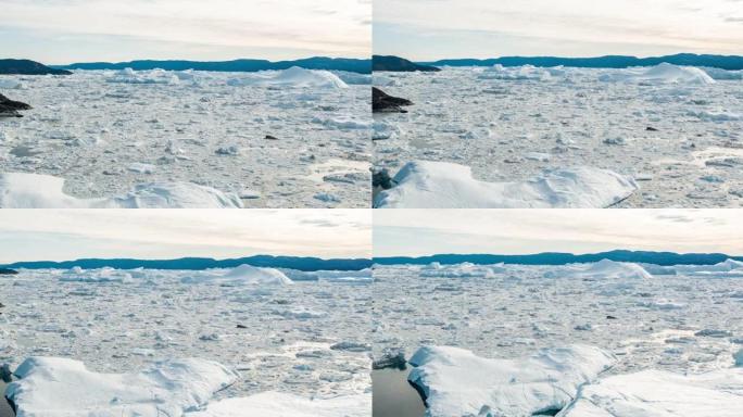 格陵兰岛北极自然景观中冰川冰山和冰的空中无人机视频。伊卢利萨特冰湾冰山的航拍视频无人机照片。受气候变