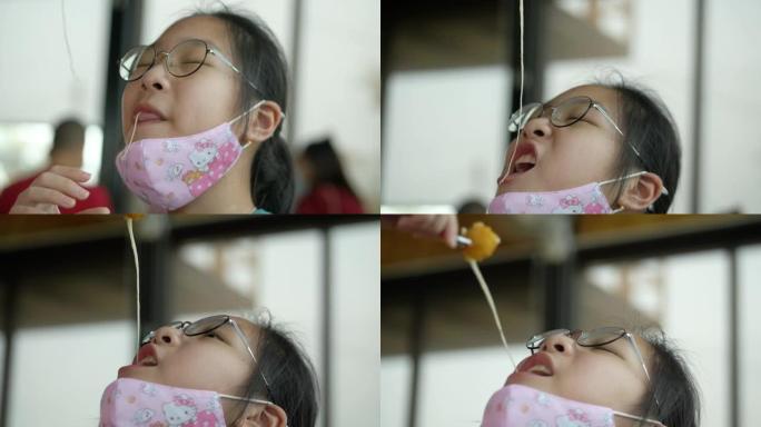 亚洲女孩在日本餐馆吃奶酪棒，有家庭生活方式的概念。
