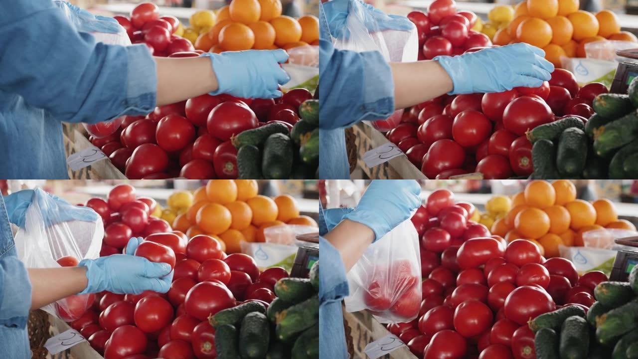 一个戴着手套的女人在市场上买西红柿，特写镜头