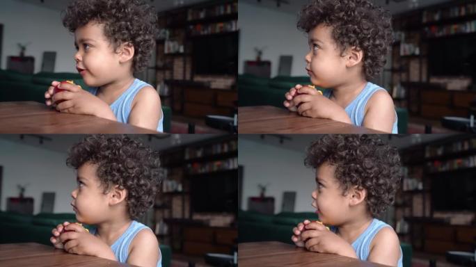 3岁黑人男孩吃桃子的肖像