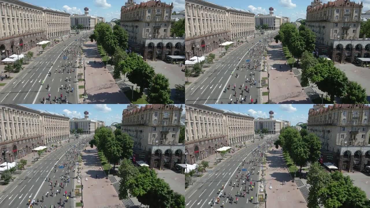 乌克兰基辅- 2021年6月5日。全乌克兰自行车手日。骑自行车的人排成纵队穿过基辅市。鸟瞰图。