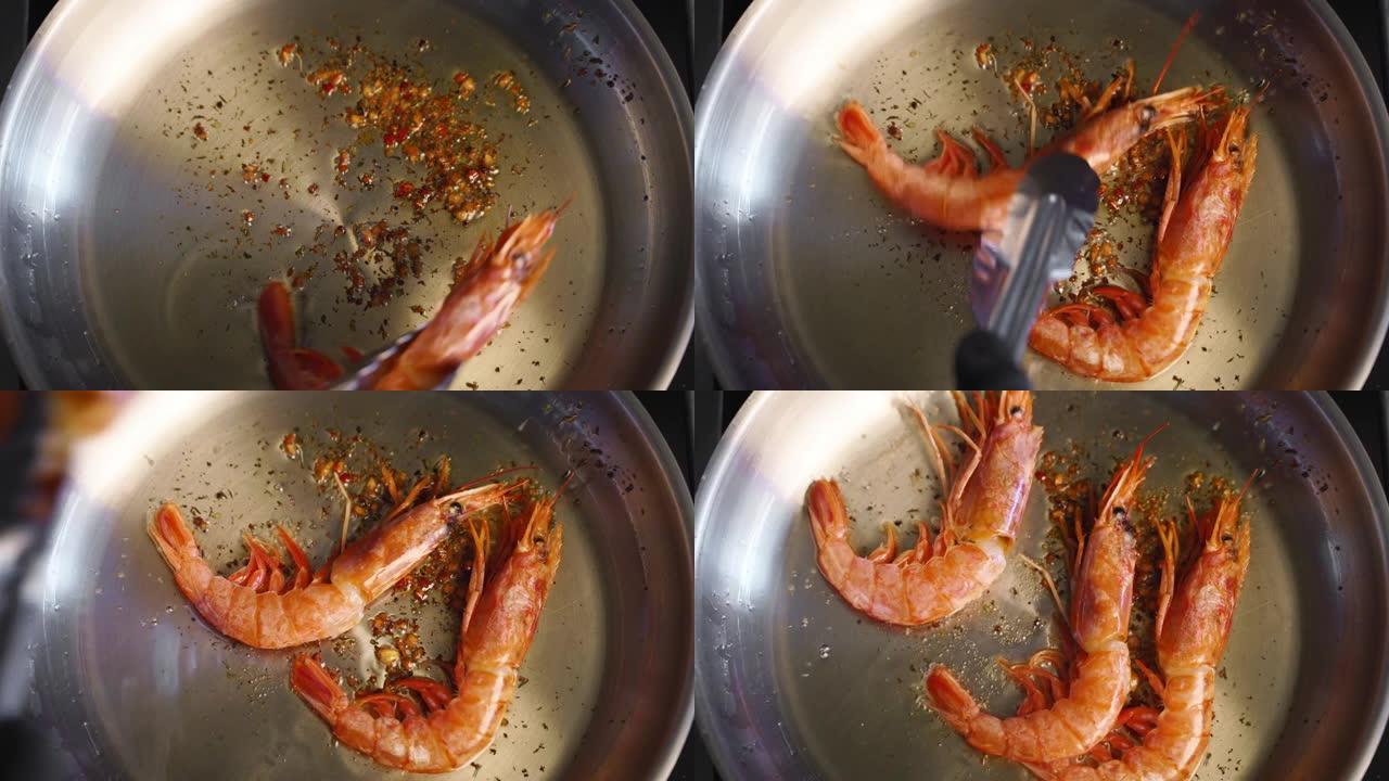 库克把虾放在烤架上。大虾在平底锅里煎炸的特写镜头。厨师在热锅上煎皇家虾。宏观海洋食品制备