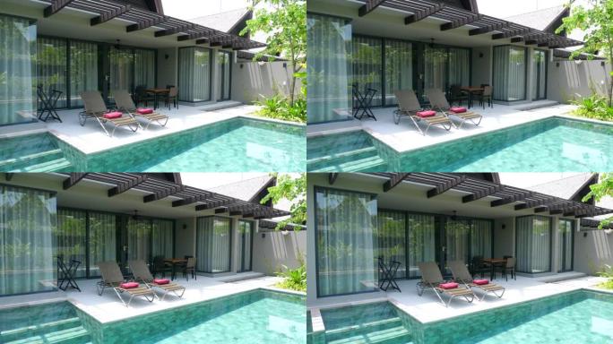 在炎热的夏日里，在游泳池附近有两张日光浴床的别墅里放松和休闲