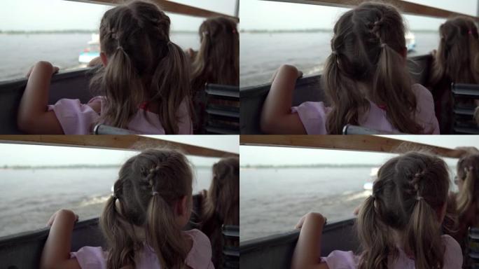 在perrilla渡轮上的女孩看着帆船。在4k河上乘船旅行