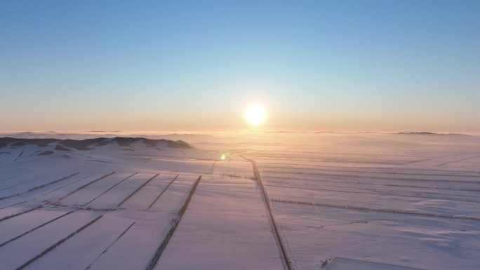 航拍4K内蒙古垦区田野雪景落日