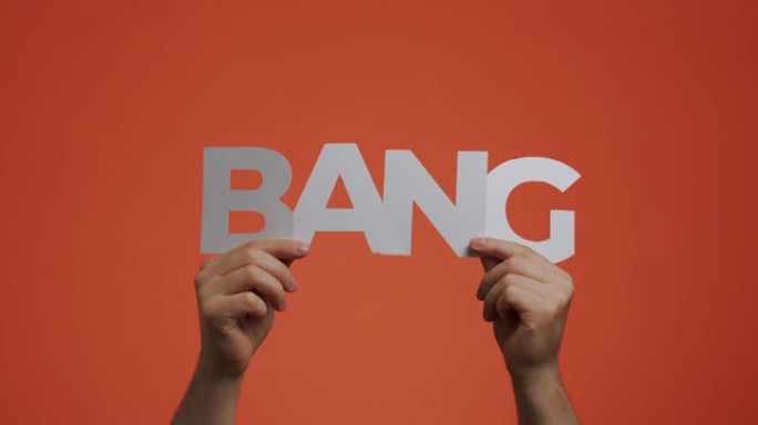 手显示由雕刻纸制成的英语单词Bang，用于博客屏幕保护程序，漫画