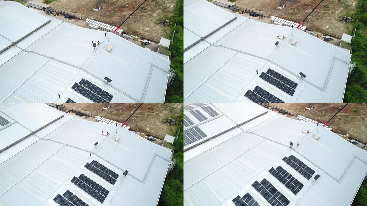 工人的鸟瞰图在屋顶上安装太阳能电池板