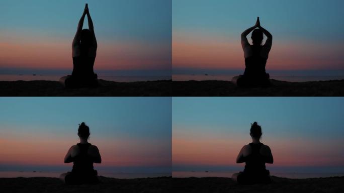 傍晚金色日落时，年轻女子在海边海滩上冥想和锻炼瑜伽Lotos姿势的剪影