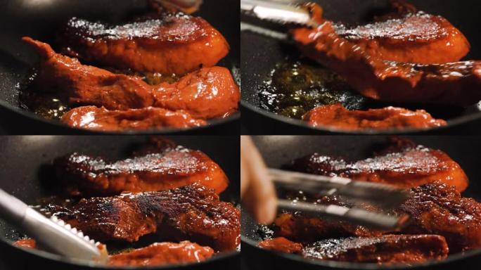 红色生猪肉在黑锅上烤。厨师翻转。美味。有些烧焦了。宏观特写镜头。