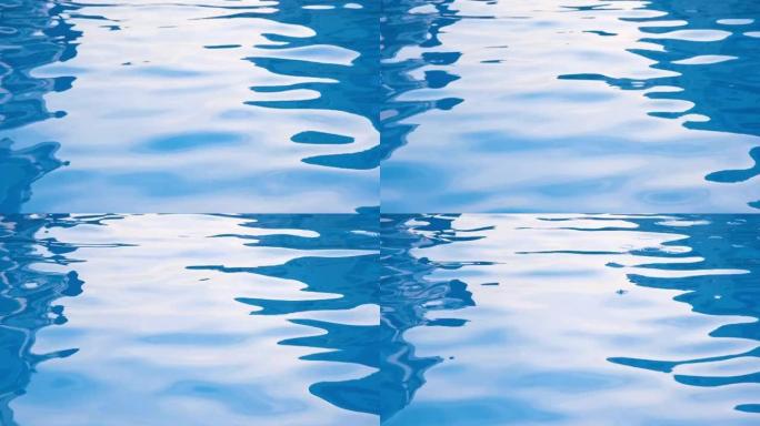 游泳池里有光线反射的纯净透明的蓝色海水。4k分辨率分辨率视频。游泳池里的水的质地。