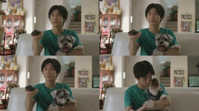 一个十几岁的男孩和他的狗在一起看电视