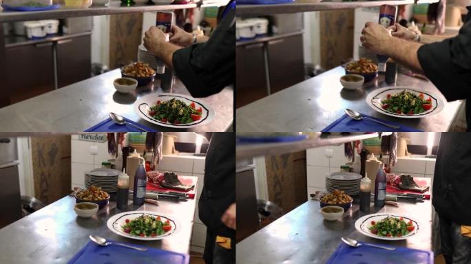 创意厨师，在沙拉碗的边缘倒酱汁，这样他就可以装饰饭菜了