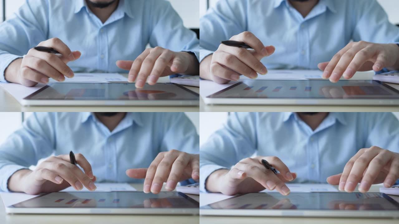 慢动作场景商人手指向办公室数字平板电脑屏幕上的仪表板统计图表，以计划或分析公司的利润或业务战略概念