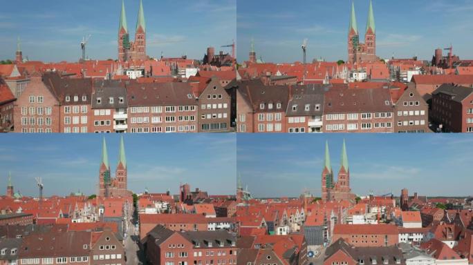 中世纪市中心的滑动展示。红砖建筑，红瓦屋顶。圣玛丽教堂的两座高塔。德国石勒苏益格-荷尔斯泰因州吕贝克