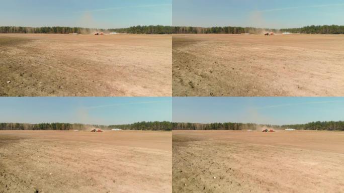 带播种机的拖拉机正在春季农田上积聚灰尘