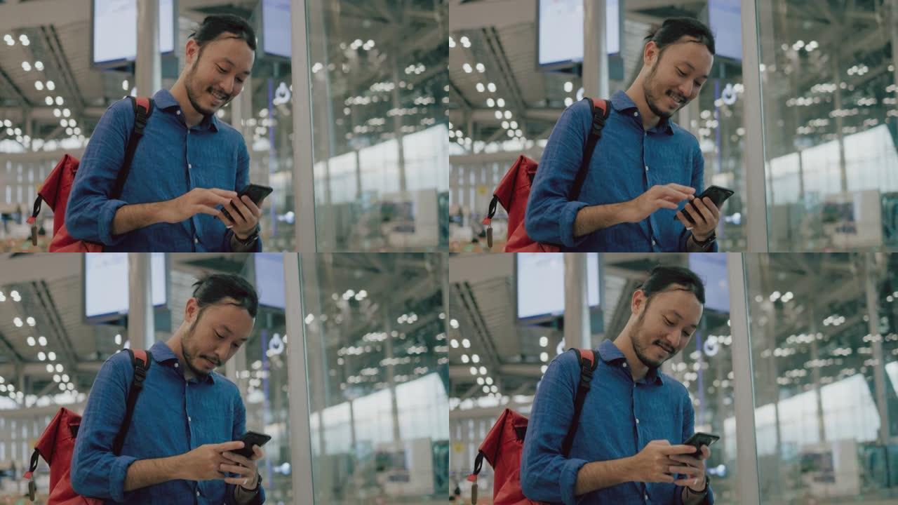 令人愉快的亚洲男性游客在机场等待办理登机手续时，用智能手机在线购物-股票视频