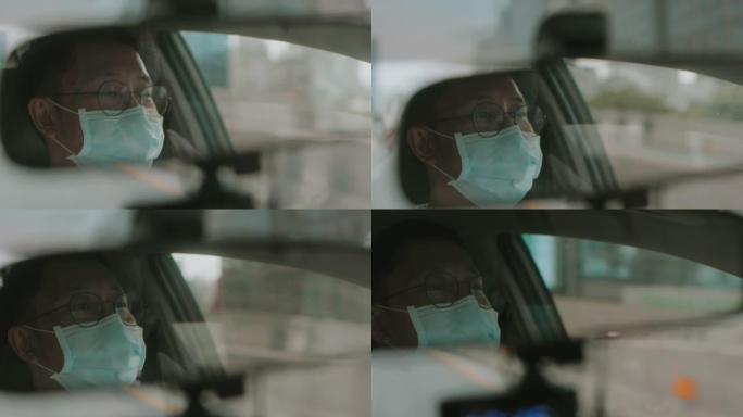 带防护面罩的亚洲中年男子的倒影开车时看智能手机上的在线路线图-股票视频
