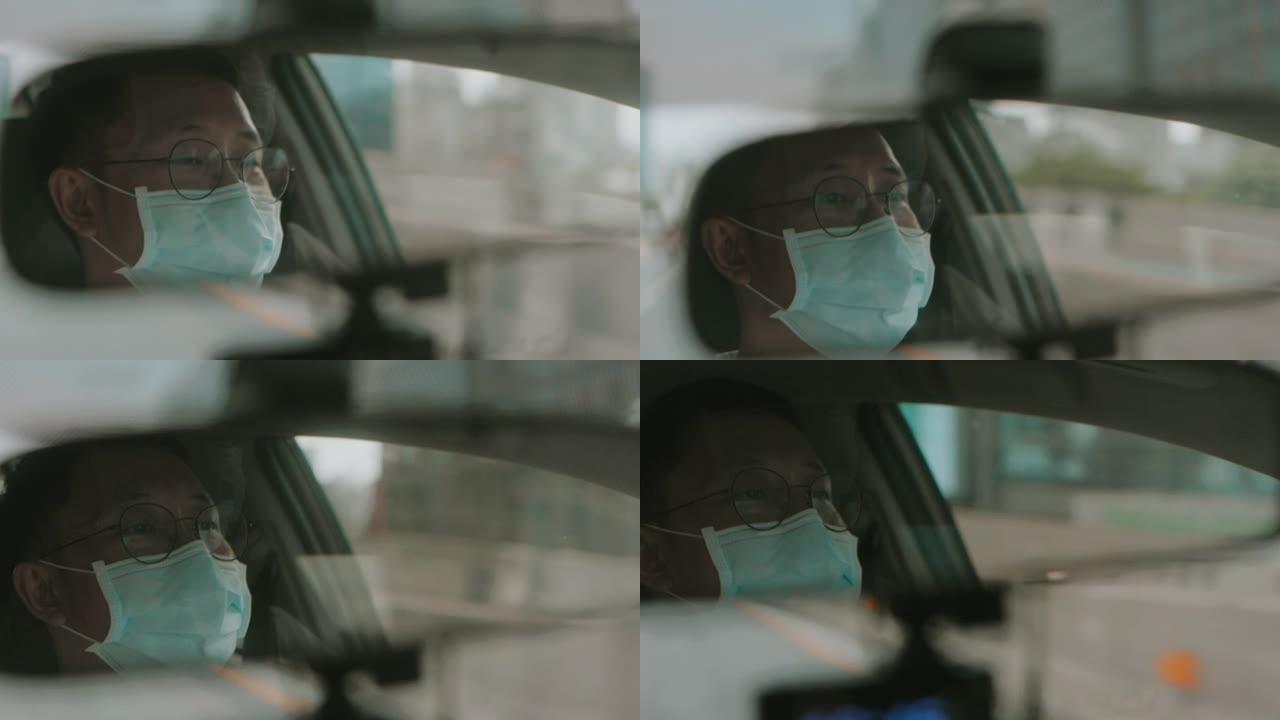 带防护面罩的亚洲中年男子的倒影开车时看智能手机上的在线路线图-股票视频