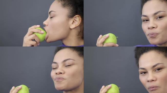 一个黑人妇女咬着青苹果的肖像。