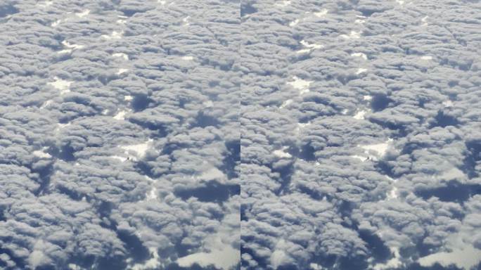 竖拍飞机上拍摄地面云海和河流城市