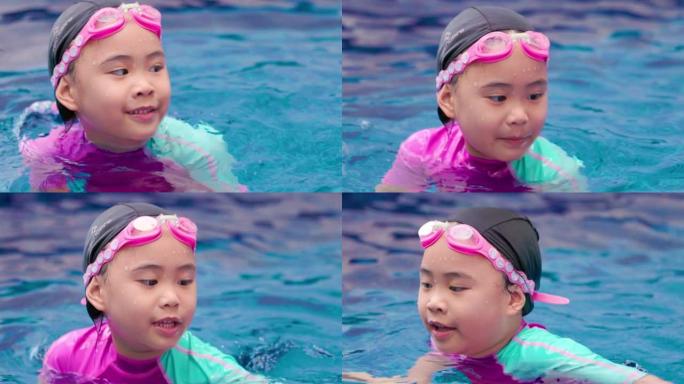 在蓝色游泳池玩耍的亚洲女孩。