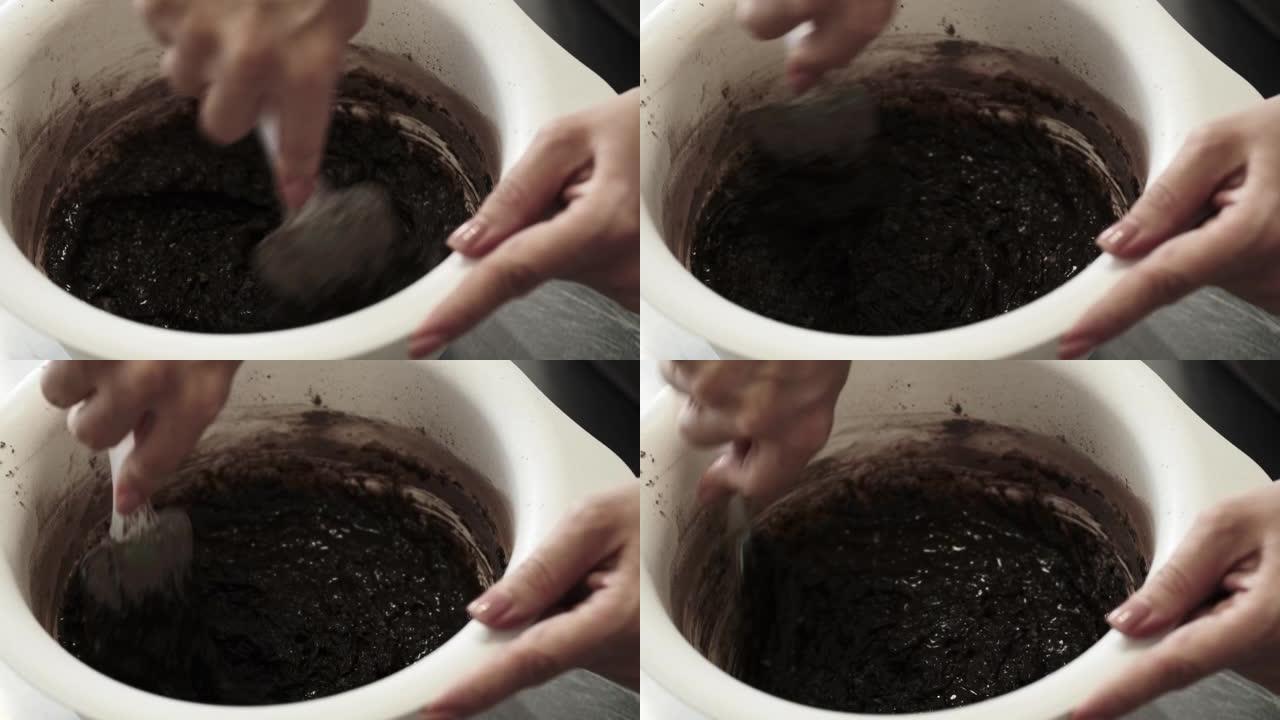 4k女糕点厨师用抹刀揉面团制作巧克力海绵蛋糕，特写镜头。慢动作。蛋糕制作过程。