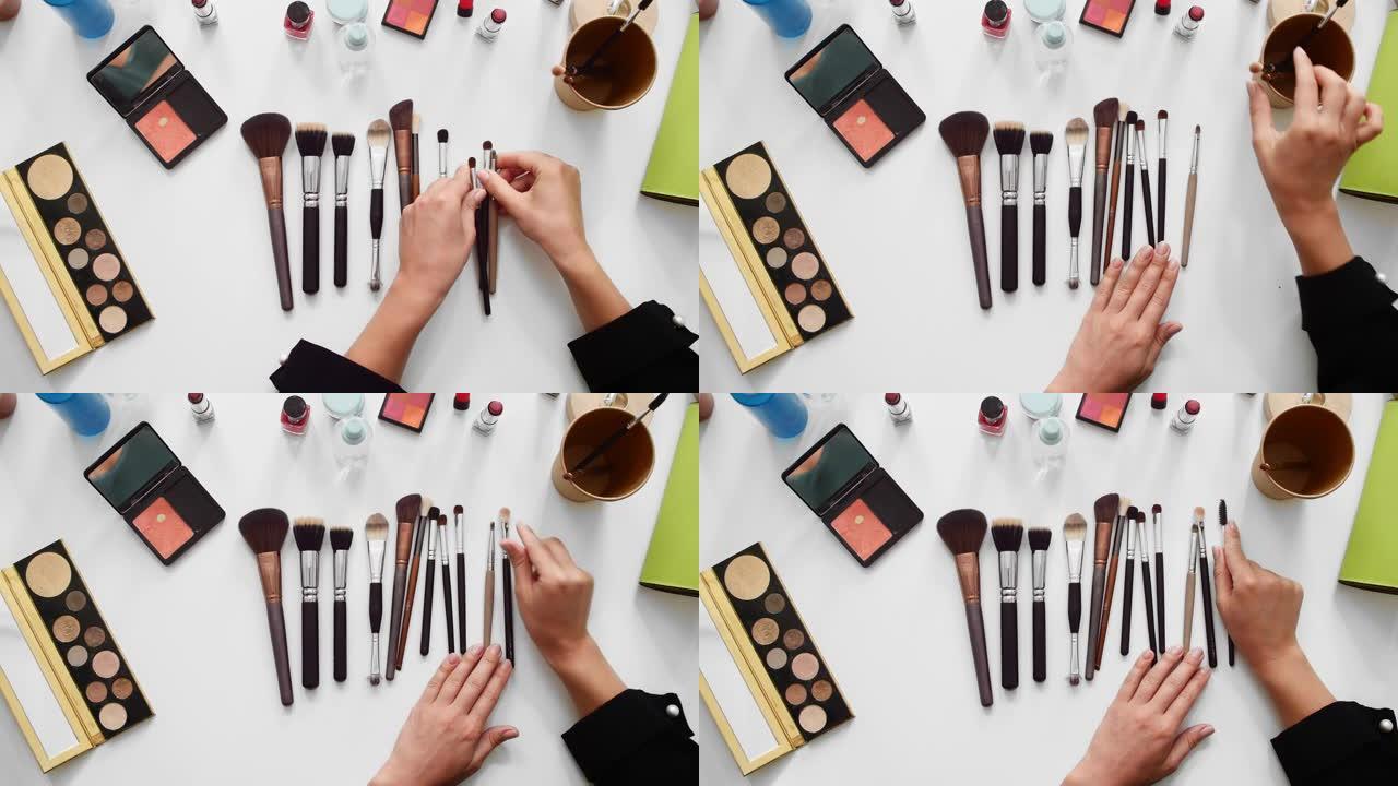 特写美容博客的俯视图镜头，在化妆教程视频中展示不同的刷子和美容产品