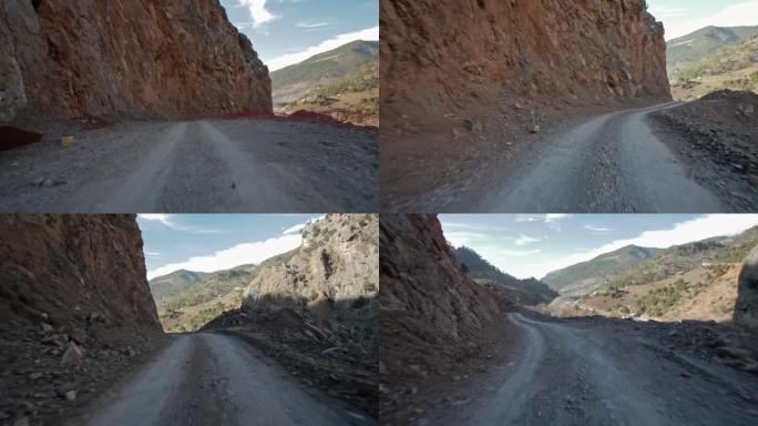 在落基山脉之间的土路上驾驶和攀爬的汽车安装视图