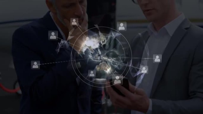全球个人资料图标网络针对两名在机场跑道上使用智能手机的商人