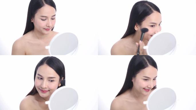 亚洲女性博客作者正在展示如何化妆和使用化妆品。在摄像机前录制工作室的vlog视频直播