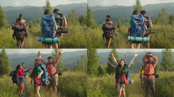 快乐快乐的多元民族背包客，举起手来庆祝成功的登山徒步旅行