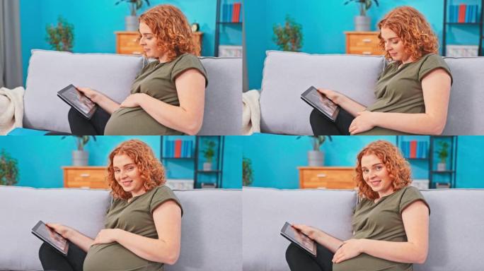 怀孕的女性在客厅用平板电脑躺在沙发上放松。她收到了在线消息，其中包含医生的结果，超声波的照片，她看着