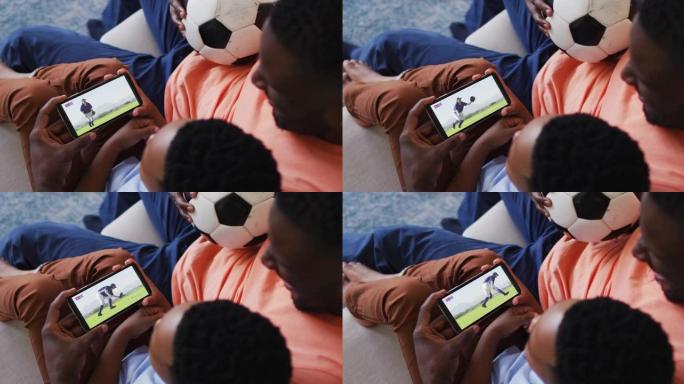 父亲和儿子的合成在智能手机上观看棒球比赛